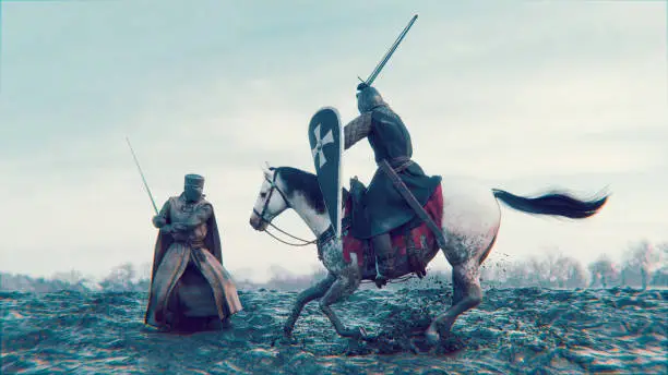 Two knights are fighting a battle with swords. One stands on the muddy ground and the other one attacks while riding on a war horse.