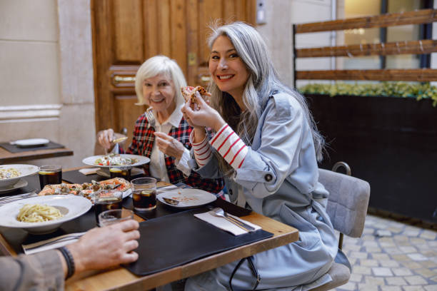 istock Cheerful women chatting and laughing in cafe 1389185622