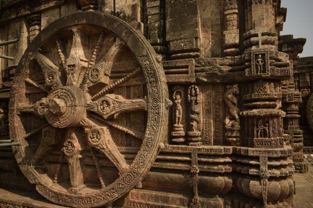 the chariot wheel konark, odisha, india - March 17, 2022 :large chariot wheel made of rock cut handcraft in a historical era, made this an super fine heritage site chariot wheel at konark sun temple india stock pictures, royalty-free photos & images