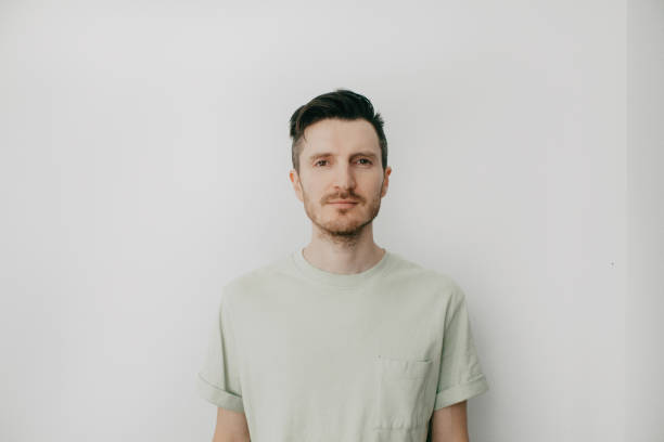 istock Handsome young man over grey wall with serious expression on face. Simple natural looking at camera 1389188739