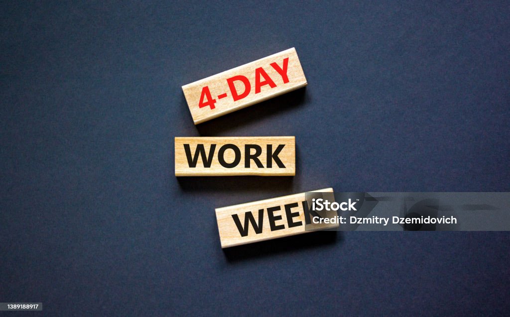 4-day work week symbol. Concept words 4-day work week on wooden blocks on beautiful black table black background. Copy space. Business and 4-day work week and short workweek concept. Week Stock Photo