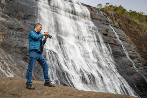 istock Photograph in front of the waterfall 1389190609