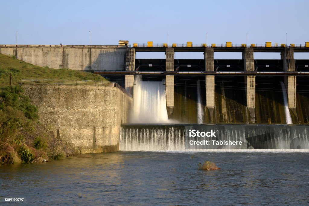 Aerial panoramic view of concrete Dam at reservoir with flowing water, hydroelectricity power station, drone shot. A Aerial panoramic view of concrete Dam at reservoir with flowing water, hydroelectricity power station Accidents and Disasters Stock Photo