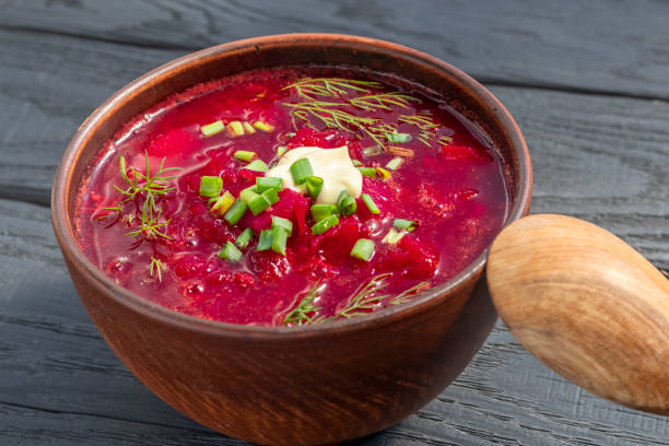 istock Ukrainian borscht  in clay bowl on black table.  Rustic style. Close-up 1389191759