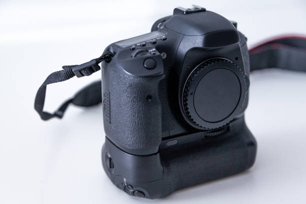 istock DSLR camera body in black color on white background. 1389192481