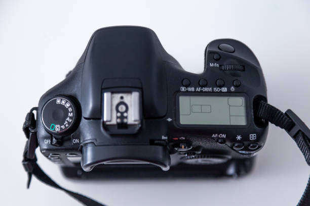 istock DSLR camera body in black color on white background. 1389192486