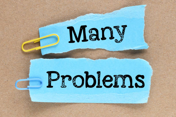 istock MANY problems words on blue sheets of paper. 1389192698