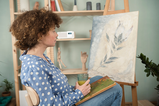 Female painter creating art in her home
