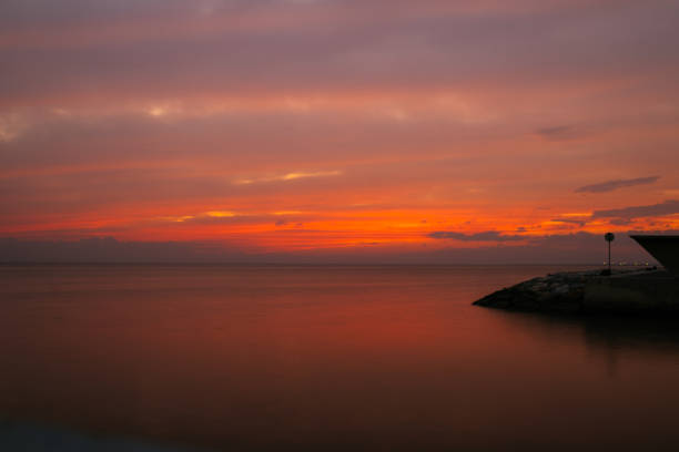 unset sky background. Dramatic gold sunset sky with evening sky clouds over the sea. Stunning sky clouds in the sunset. Sky landscape. Panoramic sky view.