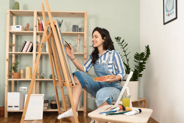 istock Carefree woman painter in her studio 1389196045
