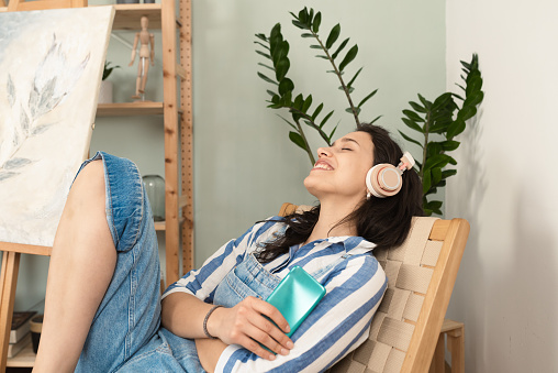 Beautiful woman listening to the music after work