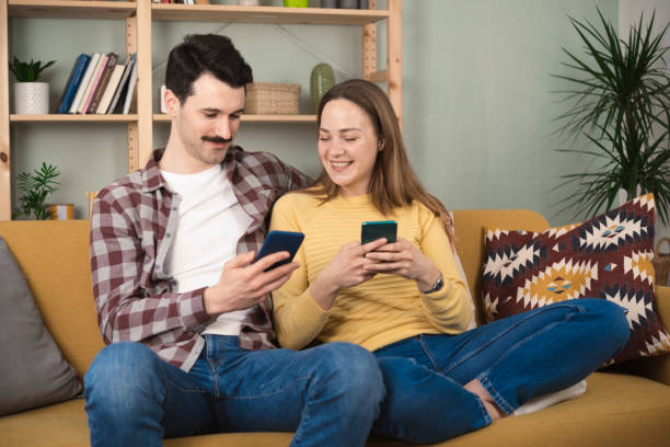 istock Cheerful couple using mobile phone 1389202657