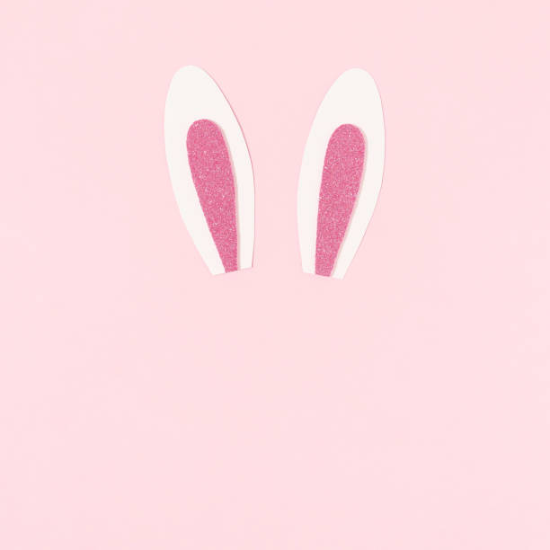 istock Bunny rabbit ears on pastel pink background.Happy Easter. Creative  minimal Easter holiday concept.  Holiday Easter celebration greeting card or idea. Flat lay 1389203377
