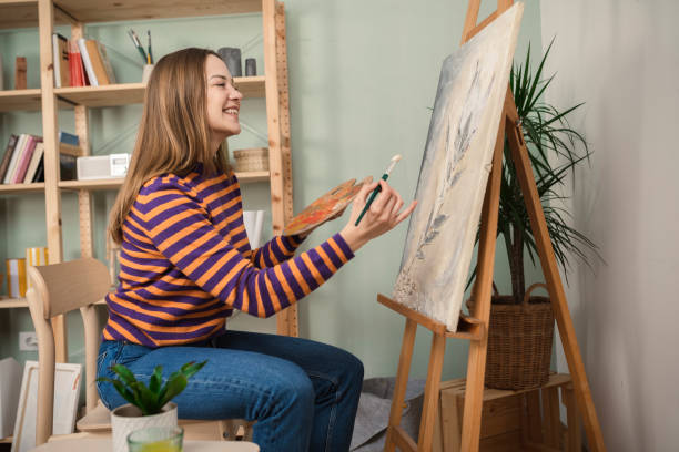 istock Beautiful painter working at her living room 1389203523
