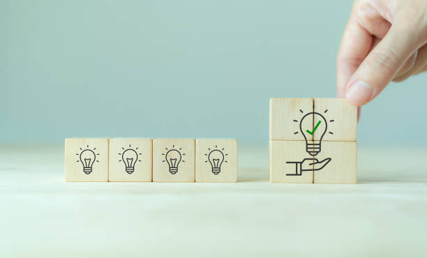 istock Suggestion and consulting concept. New idea, solution. Putting wooden cubes with light bulb on hand icon on beuatiful grey background and copy space. Business review, strategy suggestion for busines 1389203641