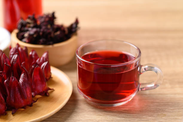 istock Roselle tea in glass on wooden background (Hibiscus sabdariffa) 1389205766