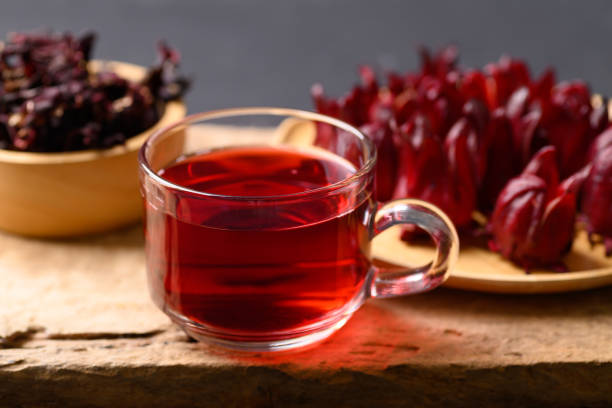 istock Roselle tea in glass on wooden background (Hibiscus sabdariffa) 1389205805