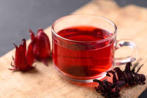 istock Roselle tea in glass on wooden background (Hibiscus sabdariffa) 1389205807