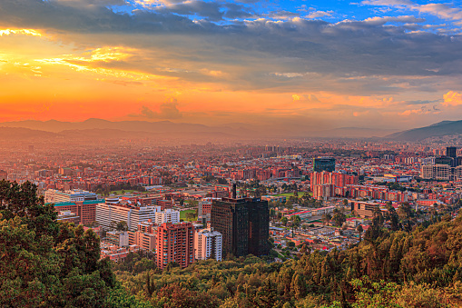 Bogota Colombia - It is sunset time in the Northern part of the Capital city and District of Usaquén in Bogotá, Colombia, South America as viewed from the heights of La Calera on the Andes Mountains. The city at street level is located at an altitude of 8,660 feet above mean sea level. Downtown Usaquén with its modern office buildings can be clearly seen. Horizontal format; copy space.