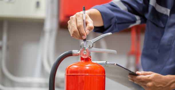 istock Engineer are checking and inspection a fire extinguishers tank in the fire control room for safety training and fire prevention. 1389214502
