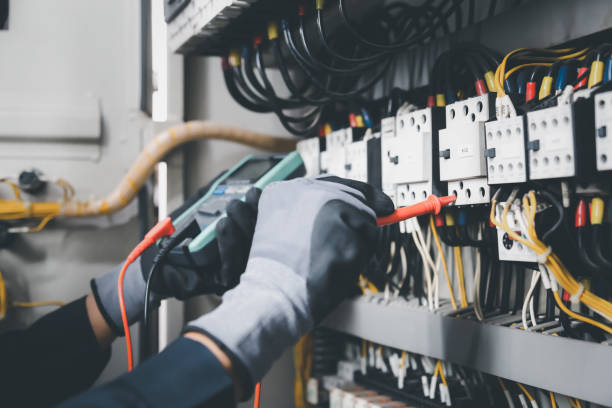 istock Electrician engineer tests electrical installations and wires on relay protection system. Adjustment of scheme of automation and control of electrical equipment. 1389214664