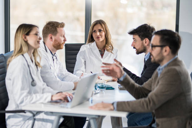 istock Doctors having a meeting with businessmen in office. 1389215900