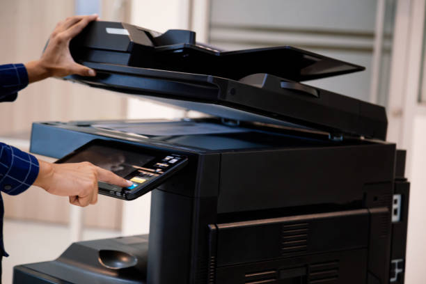 istock Businessmen press button on the panel for using photocopier or printer for printout and scanning document paper at office. 1389216042