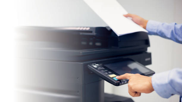 istock Bussiness man Hand press button on panel of printer, printer scanner laser in office copy machine supplies start concept. 1389216203