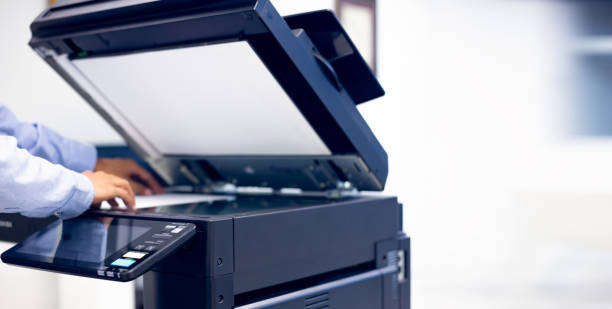 istock Bussiness man Hand press button on panel of printer, printer scanner laser in office copy machine supplies start concept. 1389216204