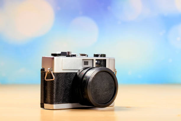 istock Retro camera on a wooden table 1389216267