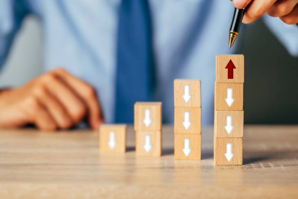 istock Hand arranging wood block stacking as step stair with arrow up.Ladder career path for business growth success process concept. 1389216323