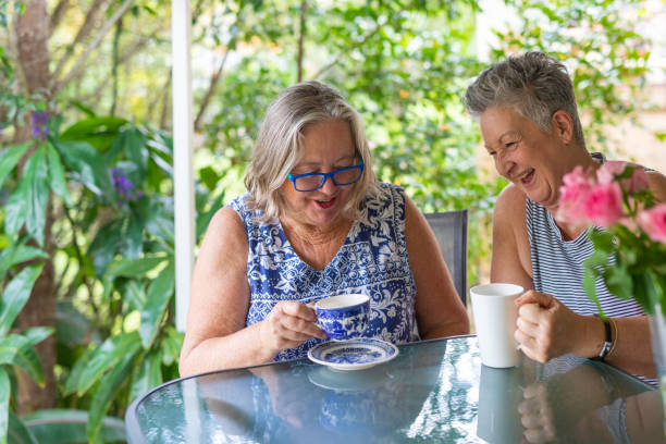 istock Senior Women Drinking Tea and Laughing Together 1389216868