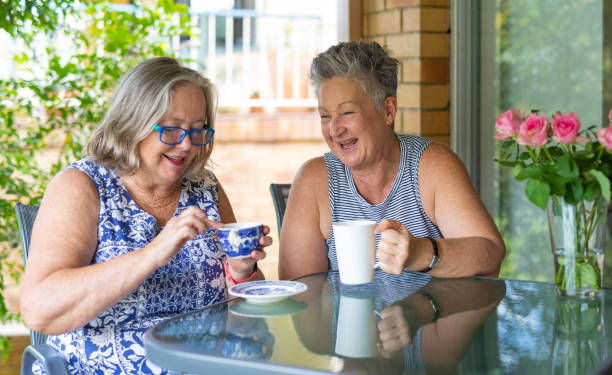 istock Senior Women Drinking Tea and Laughing Together 1389216874