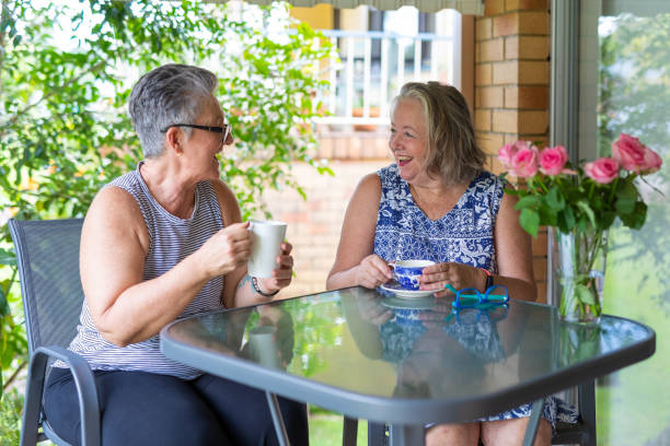 istock Senior Women Drinking Tea and Laughing Together 1389217129