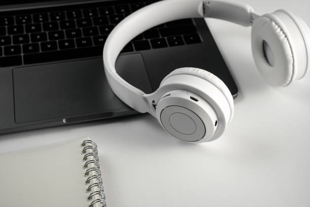istock Computer, magnifying glass, glasses, headphones and mobile phone on white background board 1389235290