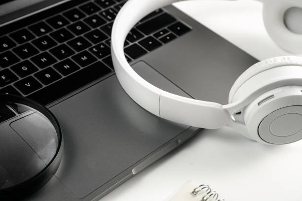 istock Computer, magnifying glass, glasses, headphones and mobile phone on white background board 1389235301