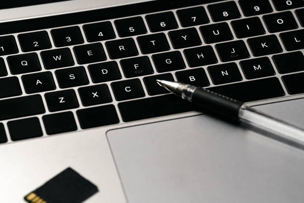 istock Computer, mobile phone, pen and memory card on white background board 1389235540