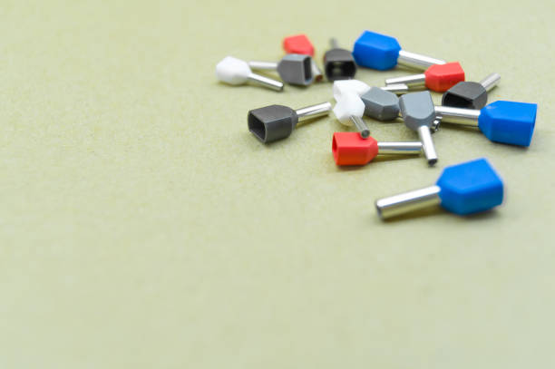 istock Coloured crimp terminals for different wire sizes. Copper sleeves for crimping electrical cables. Ferrules. Selective focus, copy space 1389238086
