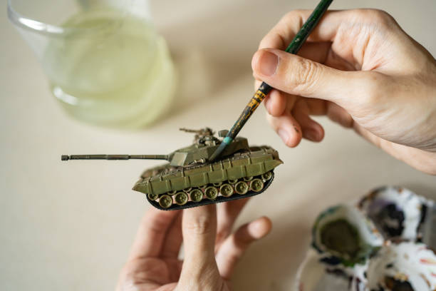 istock Painting tank plastic model with brush 1389239924