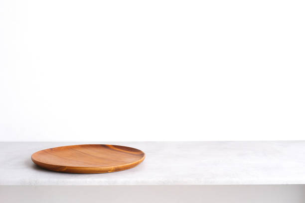 istock Empty round wooden plate on gray cement table background, banner with copy space, Blank wood tray for food display montage, template, mock up, top view, flat lay 1389243874