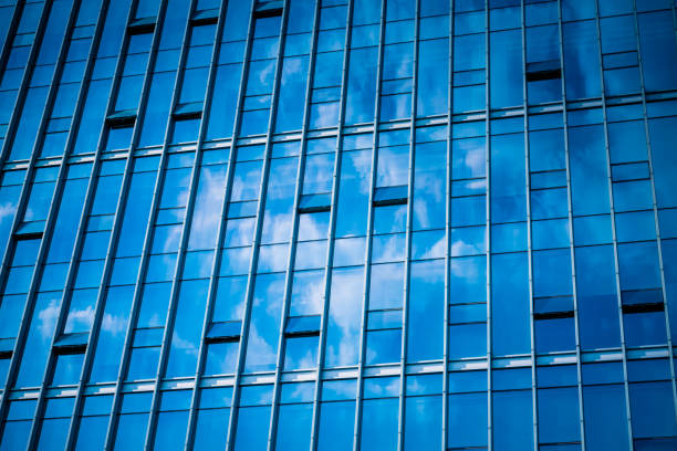 istock Clouds Reflected in Windows of Modern Office Building 1389247863