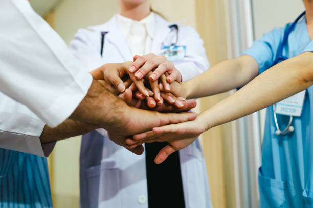 istock Doctor and nurse  handshake close up for teamwork concept. 1389248625