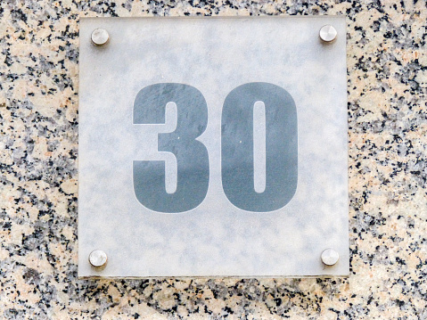 Metal home number on a wall