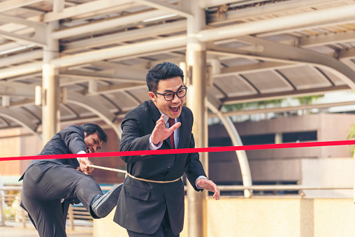 Business competition group of business people in formal suit run to finish line success goal victory strategy. Competitive person race to be first place winner. Multiethnic diversity people contest.