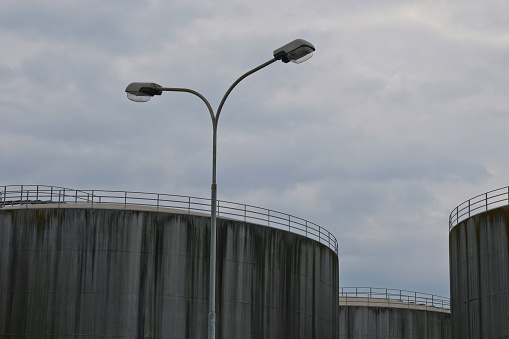 Grim detail shot of storage silos in an industrial area. Concept for the upcoming bleak situation of fuel shortage.