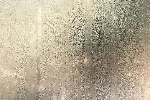Condensate drops on the glass of a plastic window. Freezing and the formation of condensation and mold on the new plastic window. Defect in installation. Problem. Selective focus