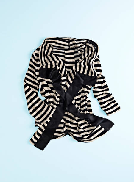 istock Black and white striped cardigan isolated on blue background 1389263277