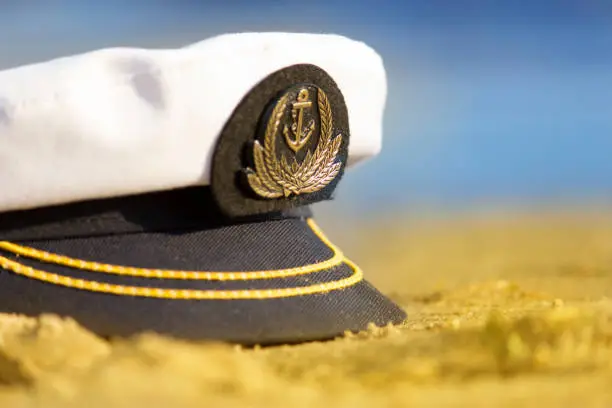 Sailor hat on the sand. Travel concept. Copy space