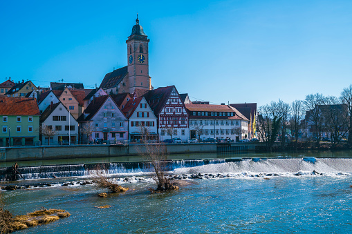 Germany, Historic district houses of nuertingen city skyline behind beautiful water of neckar river on sunny day