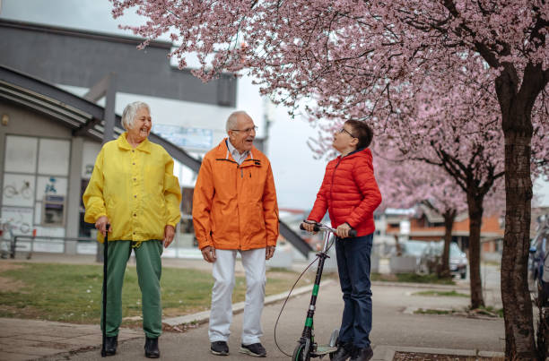 istock Old people walking in the spring with grandson 1389269173